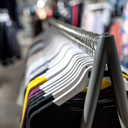 Stylish clothes on hangers in a retail fashion store. Perfect for shopping and lifestyle themes.